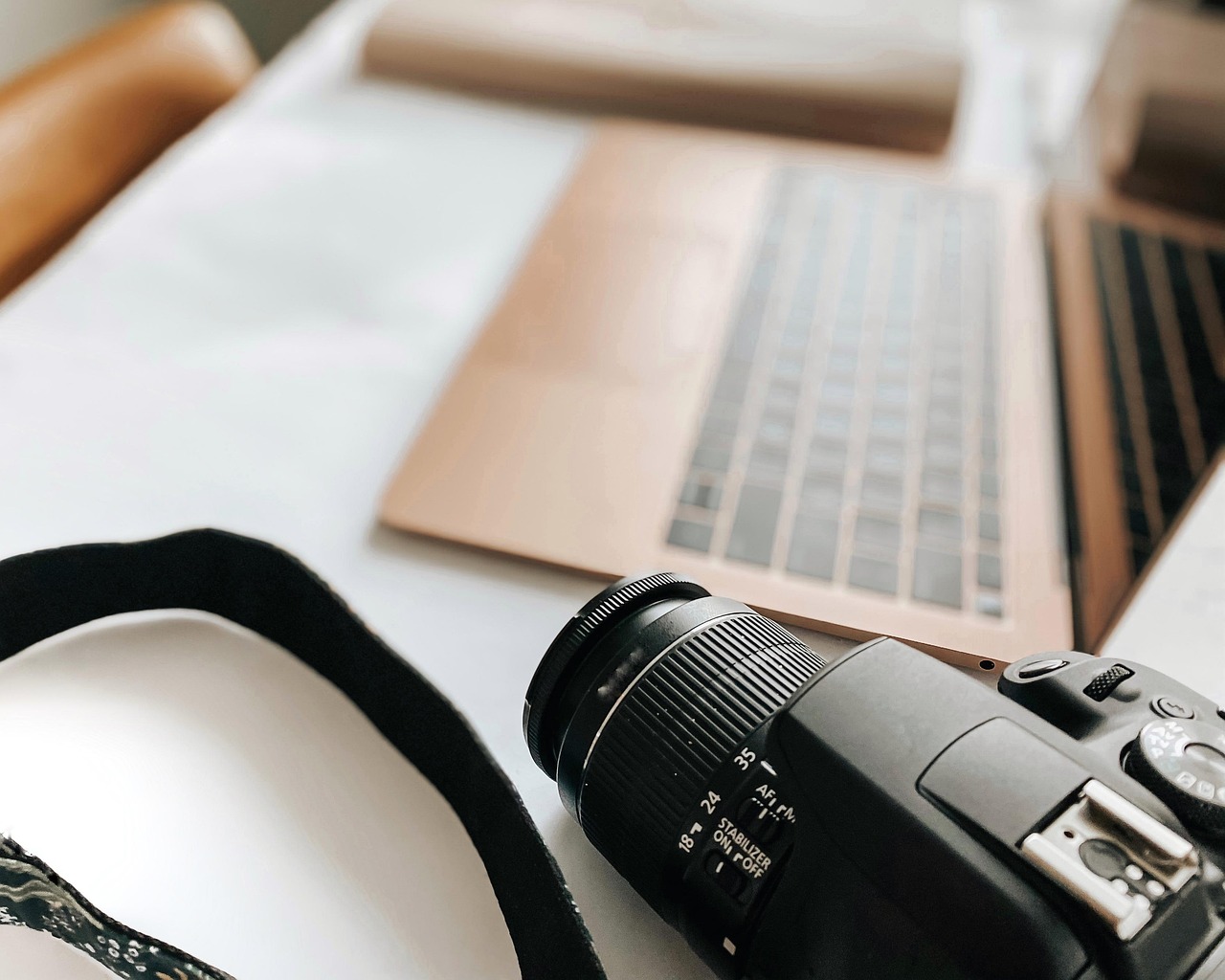 Laptop, camera, desk — "Boosting Your Agency's Offerings with White Label PPC"